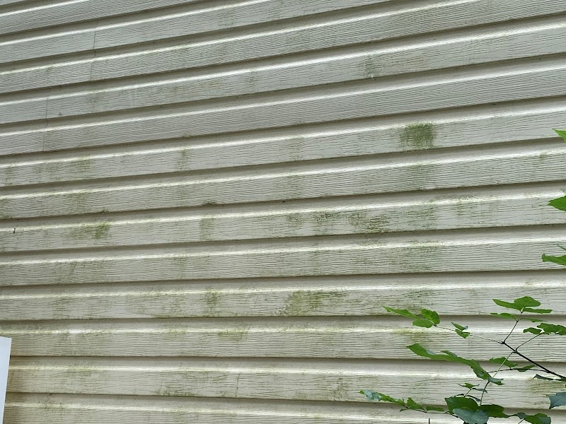 Pressure washed home exterior showing dramatic before and after results